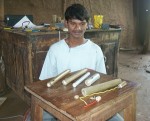 Ishvar with the four torches he has made. And the parts of a fifth torch. Two of the torches are made of bamboo and two are from a plastic pipe.